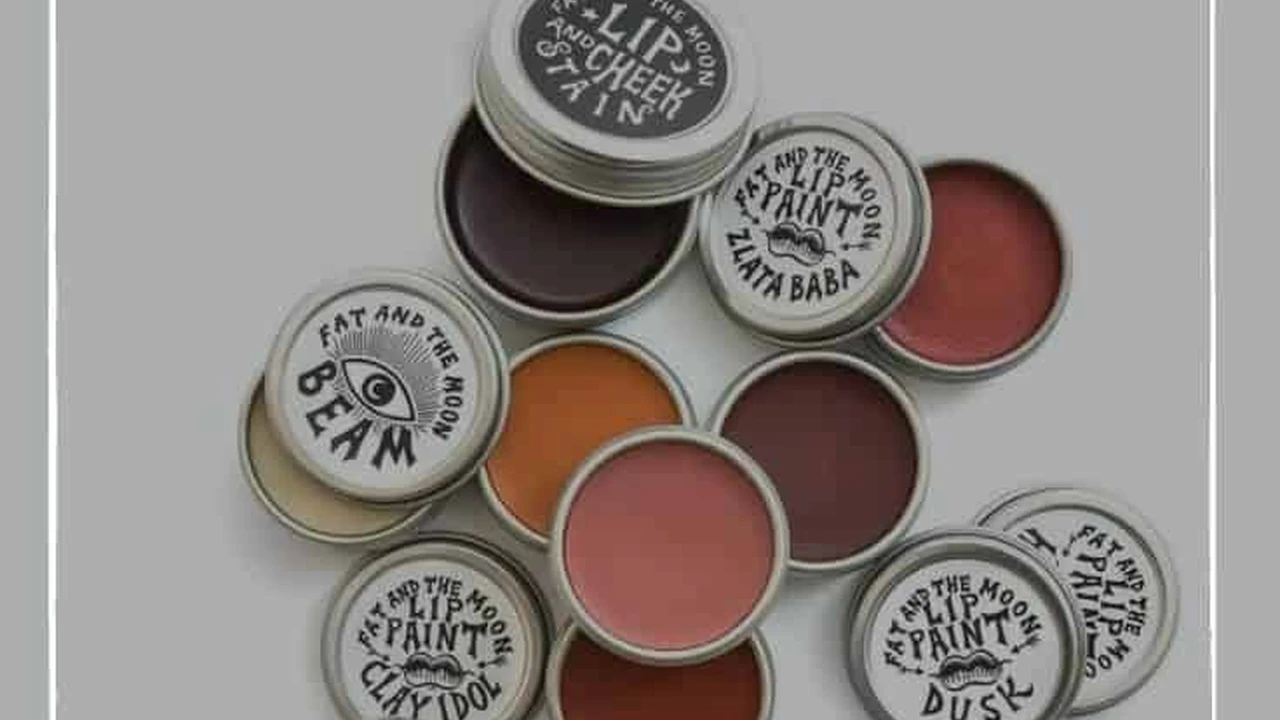 blue bowl of black bean beef tortilla soup on a board with cilantro and shredded cheese in background