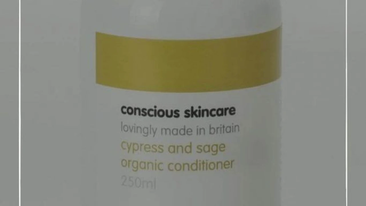 Close up on a plate of mashed potatoes, topped with baked pork chops with cream of mushroom soup, and a side of green beans.