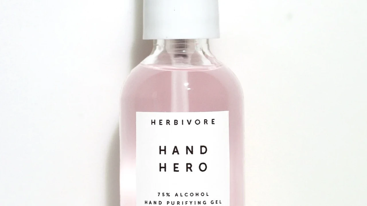 Close up on a plate of mashed potatoes, topped with baked pork chops with cream of mushroom soup, and a side of green beans.