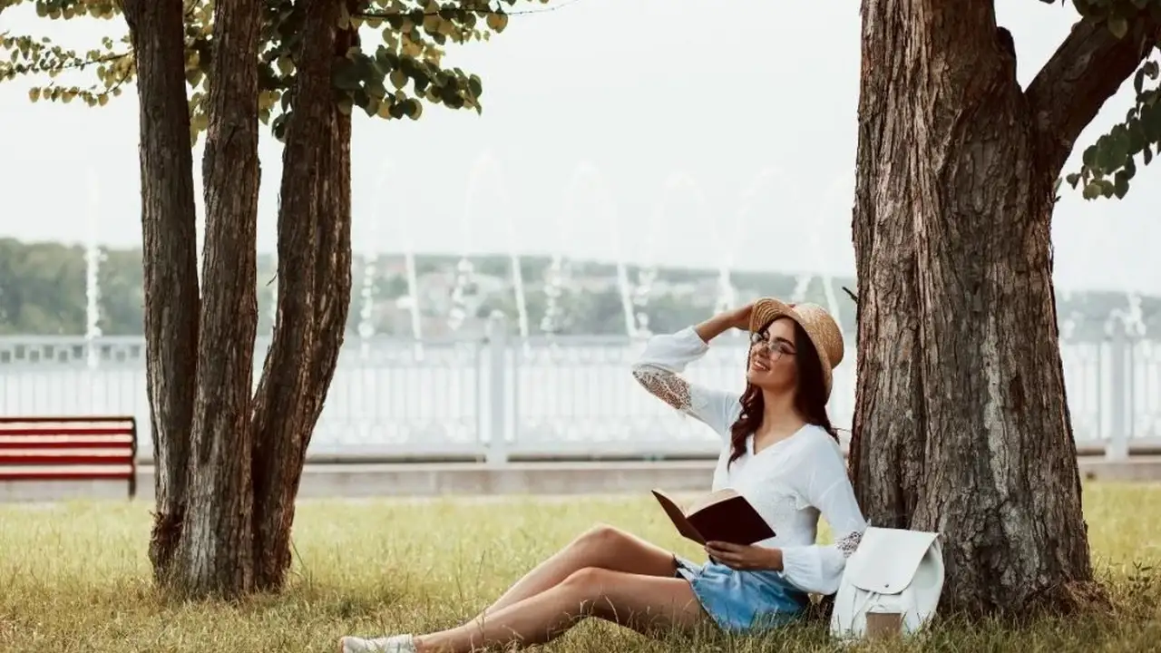 Close up on a plate of mashed potatoes, topped with baked pork chops with cream of mushroom soup, and a side of green beans.