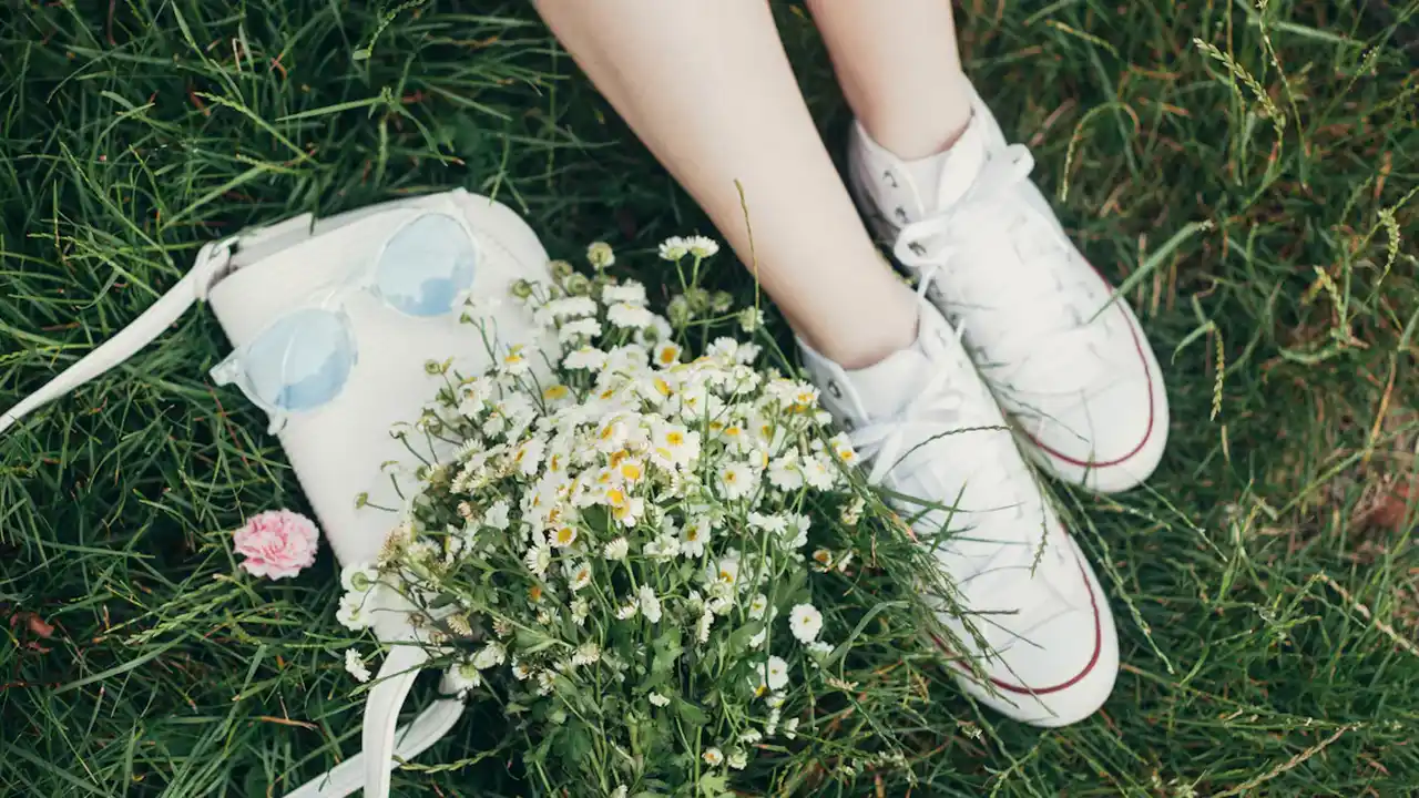 Close up on a plate of mashed potatoes, topped with baked pork chops with cream of mushroom soup, and a side of green beans.
