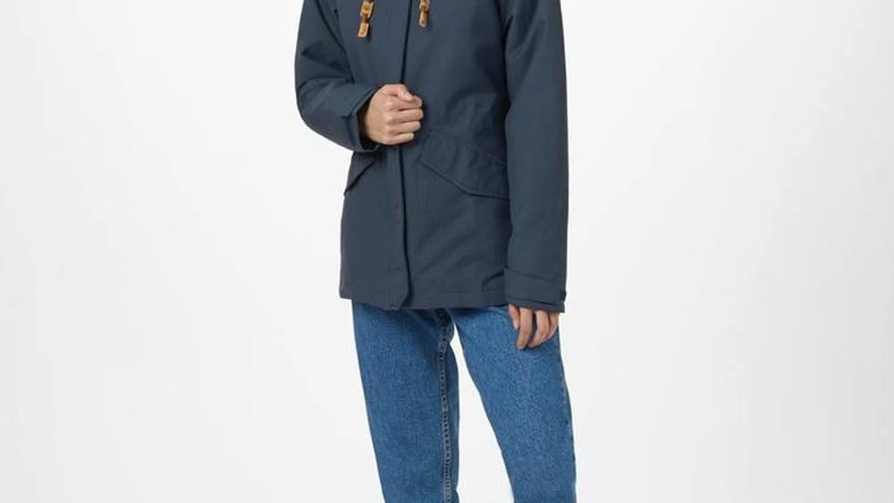 Close up on a plate of mashed potatoes, topped with baked pork chops with cream of mushroom soup, and a side of green beans.